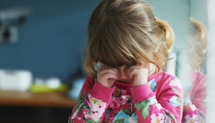 Young girl rubbing eyes
