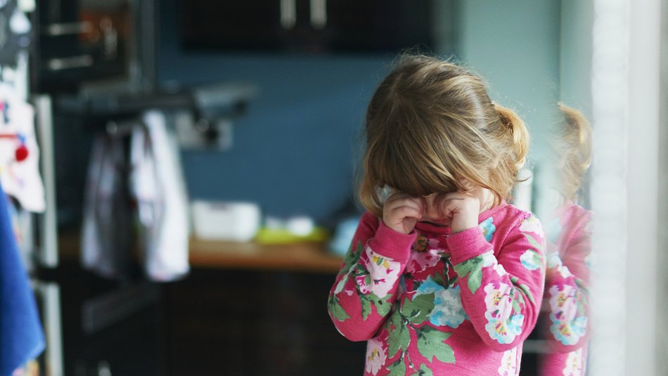 Young girl rubbing eyes