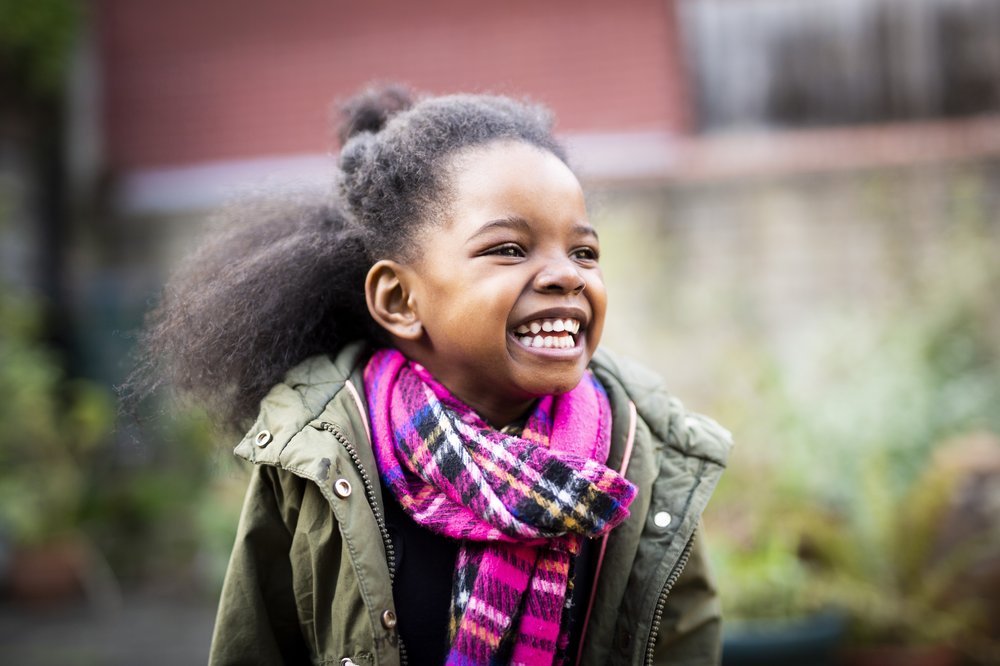 Young girl smiling outdoors