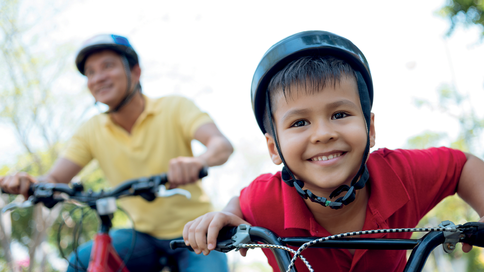 Young boy and his dad on bikes