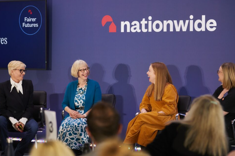 Four women sitting on a stage discussing Nationwide partnership