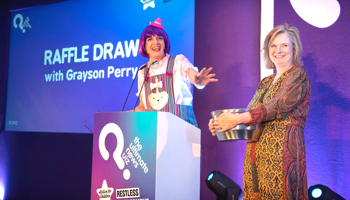 Grayson Perry speaking on stage at The Ultimate News Quiz