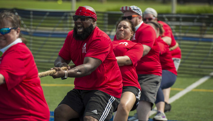 Group of people playing tug of war
