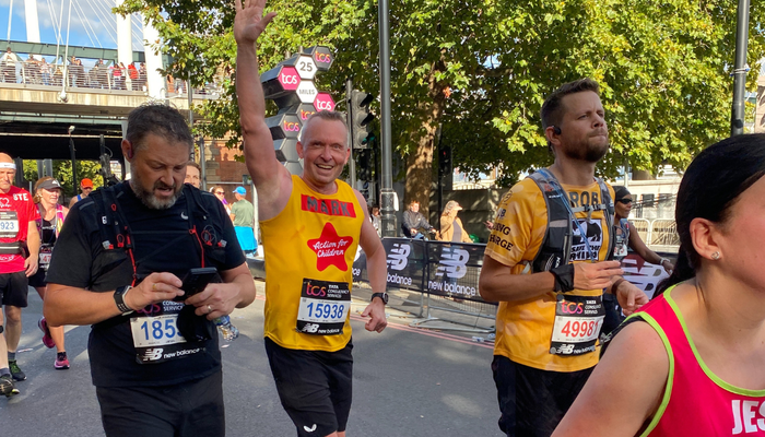 Mark in an Action for Children runing vest running the London Marathon