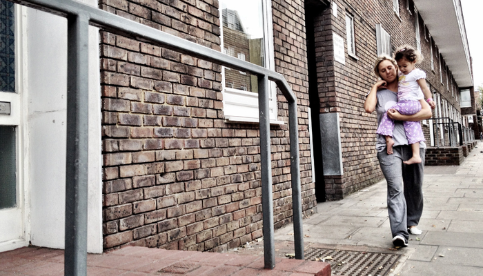 Mother and daughter walking outside council flat (flipped and cropped) 940x636px