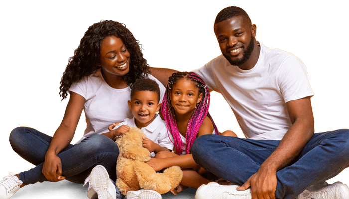 Happy mother and father posing with children and teddy bear
