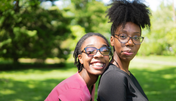 Two smiling sisters in garden